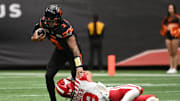 Jun 15, 2024; Vancouver, British Columbia, CAN; BC Lions quarterback Vernon Adams Jr (3) makes a catch during the first half against Calgary Stampeders defensive back Branden Dozier (3) at BC Place. Mandatory Credit: Simon Fearn-Imagn Images