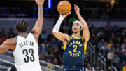 Apr 1, 2024; Indianapolis, Indiana, USA; Indiana Pacers guard Andrew Nembhard (2) shoots the ball while  Brooklyn Nets center Nic Claxton (33) defends in the first half at Gainbridge Fieldhouse. Mandatory Credit: Trevor Ruszkowski-USA TODAY Sports