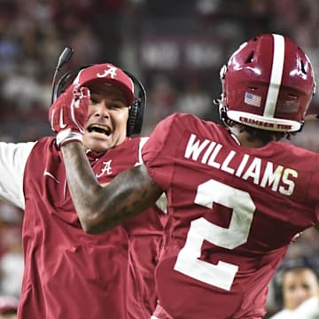 Sep 7, 2024; Tuscaloosa, Alabama, USA;  Alabama Crimson Tide wide receiver Ryan Williams (2) celebrates an assistant coach after scoring a touchdown agains the South Florida Bulls at Bryant-Denny Stadium. Alabama won 42-16. 