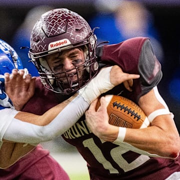 Grundy Center's Judd Jirovsky (12) runs the ball up the middle on Thursday, Nov. 21, 2024, at the UNI-Dome in Cedar Falls, IA.