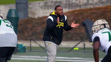 New offensive line coach A'lique Terry, center, runs a drill during the first practice of spring for Oregon football Thursday March 16, 2023.

Eug 031623 Uo Spring Fb 14