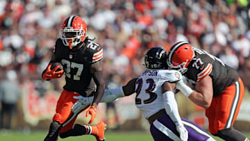 Cleveland Browns running back D'Onta Foreman (27) rushes for yards past a hold from guard Wyatt Teller (77) during the first half of an NFL football game at Huntington Bank Field, Sunday, Oct. 27, 2024, in Cleveland, Ohio.