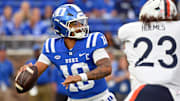 Nov 15, 2025; Durham, North Carolina, USA;  Duke Blue Devils quarter back Darian Mensah (10) drops back for a pass against Virginia Cavaliers defensive lineman Jacob Holmes (23) during the first quarter at Wallace Wade Stadium. Mandatory Credit: Zachary Taft-Imagn Images