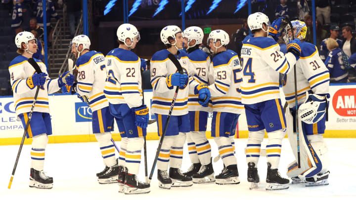 Apr 15, 2024; Tampa, Florida, USA;  Buffalo Sabres goaltender Eric Comrie (31), center Dylan Cozens (24) and teammates celebrate after they beat the Tampa Bay Lightning during the third period at Amalie Arena. Mandatory Credit: Kim Klement Neitzel-USA TODAY Sports