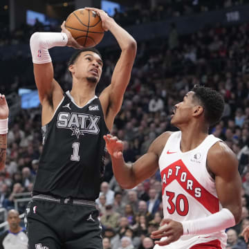 Feb 12, 2024; Toronto, Ontario, CAN; San Antonio Spurs center Victor Wembanyama (1) shoots against Toronto Raptors guards Bruce Brown (11) and Ochai Agbaji (30). 