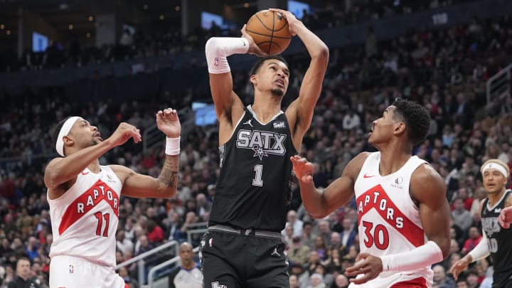 Feb 12, 2024; Toronto, Ontario, CAN; San Antonio Spurs center Victor Wembanyama (1) shoots against Toronto Raptors guards Bruce Brown (11) and Ochai Agbaji (30). 