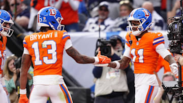 Oct 26, 2025; Denver, Colorado, USA;  Denver Broncos wide receiver Troy Franklin (11) celebrates with wide receiver Pat Bryant (13) after scoring a touchdown against the Dallas Cowboys in the fourth quarter at Empower Field at Mile High. Mandatory Credit: Ron Chenoy-Imagn Images