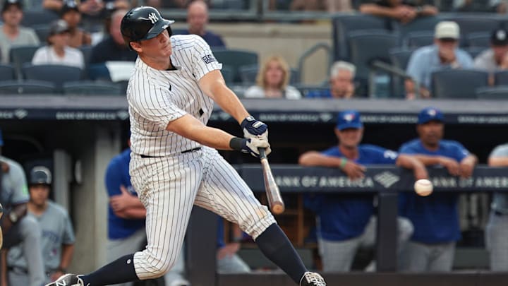 Aug 4, 2024; Bronx, New York, USA; New York Yankees third baseman DJ LeMahieu (26) hits an game-winning RBI singe during the tenth inning against the Toronto Blue Jays at Yankee Stadium. Mandatory Credit: Vincent Carchietta-Imagn Images