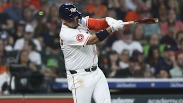May 10, 2025; Houston, Texas, USA; Houston Astros third baseman Isaac Paredes (15) hits a single during the first inning against the Cincinnati Reds at Daikin Park. 
