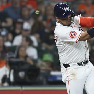May 10, 2025; Houston, Texas, USA; Houston Astros third baseman Isaac Paredes (15) hits a single during the first inning against the Cincinnati Reds at Daikin Park. 