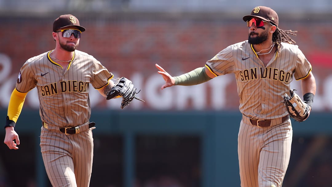 May 24, 2025; Atlanta, Georgia, USA; San Diego Padres right fielder Fernando Tatis Jr. (23) celebrates after a catch with center fielder Jackson Merrill (3) against the Atlanta Braves in the first inning at Truist Park. Mandatory Credit: Brett Davis-Imagn Images