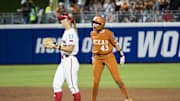 Jun 5, 2025; Oklahoma City, OK, USA;  Texas Longhorns utility Leighann Goode (43) yells after hitting a double as Texas Tech Red Raiders infielder Hailey Toney (32) looks on in the seventh inning during game two of the NCAA Softball Women's College World Series finals at Devon Park. Mandatory Credit: Brett Rojo-Imagn Images