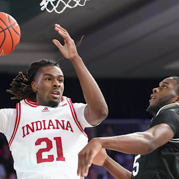 Indiana forward Mackenzie Mgbako (21) looks to pass as Providence forward Oswin Erhunmwunse (55) defends during the Battle 4 Atlantis.