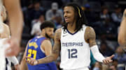 Feb 25, 2023; Memphis, Tennessee, USA; Memphis Grizzlies guard Ja Morant (12) reacts to a foul call during the first half against the Denver Nuggets at FedExForum.