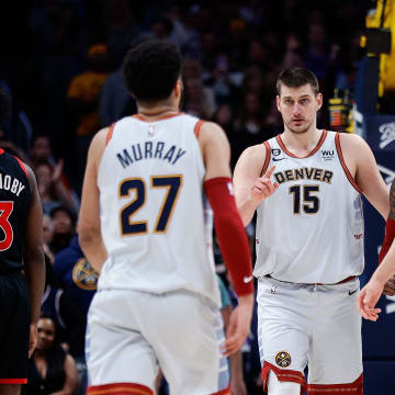 Mar 6, 2023; Denver, Colorado, USA; Denver Nuggets center Nikola Jokic (15) with guard Kentavious Caldwell-Pope (5) and forward Michael Porter Jr. (1) and guard Jamal Murray (27) in the fourth quarter against the Toronto Raptors at Ball Arena. 