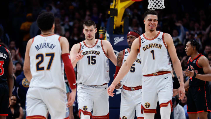 Mar 6, 2023; Denver, Colorado, USA; Denver Nuggets center Nikola Jokic (15) with guard Kentavious Caldwell-Pope (5) and forward Michael Porter Jr. (1) and guard Jamal Murray (27) in the fourth quarter against the Toronto Raptors at Ball Arena. 