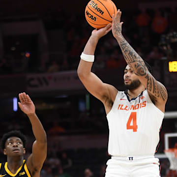 Mar 13, 2025; Indianapolis, IN, USA; Illinois Fighting Illini guard Kylan Boswell (4) shoots over Iowa Hawkeyes guard Drew Thelwell (3) during the first half at Gainbridge Fieldhouse. Mandatory Credit: Robert Goddin-Imagn Images