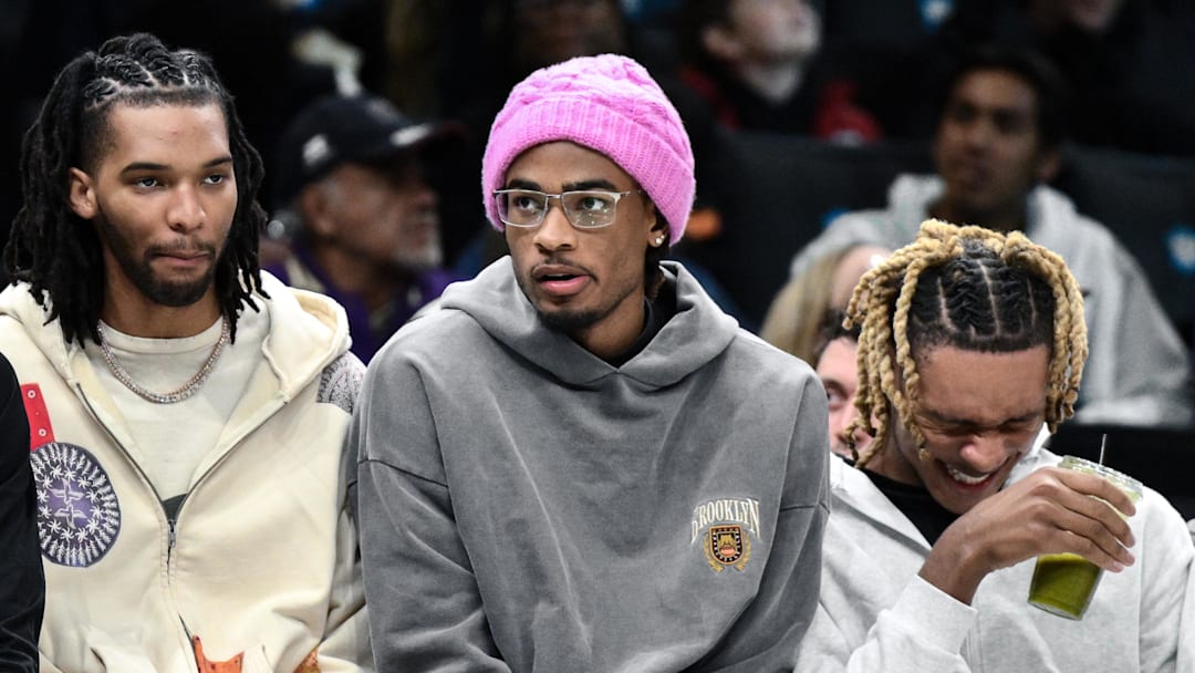 Apr 7, 2026; Brooklyn, New York, USA; Injured Brooklyn Nets players Ziaire Williams (l) and Nic Claxton and Noah Clowney (21) look on during the first half against the Milwaukee Bucks at Barclays Center. Mandatory Credit: John Jones-Imagn Images