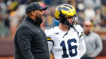 Michigan head coach Sherrone Moore talks to quarterback Davis Warren (16) at warmup during the spring game at Michigan Stadium in Ann Arbor on Saturday, April 20, 2024.