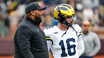 Michigan head coach Sherrone Moore talks to quarterback Davis Warren (16) at warmup during the spring game at Michigan Stadium in Ann Arbor on Saturday, April 20, 2024.
