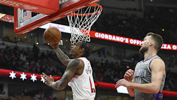 Mar 15, 2023; Chicago, Illinois, USA; Chicago Bulls forward DeMar DeRozan (11) scores past Sacramento Kings forward Domantas Sabonis (10) during the first half at the United Center. Mandatory Credit: Matt Marton-Imagn Images