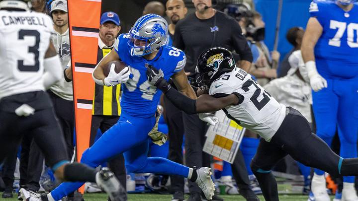 Nov 17, 2024; Detroit, Michigan, USA; Detroit Lions tight end Shane Zylstra (84) runs with the ball in front of Jacksonville Jaguars linebacker Foyesade Oluokun (23) during the first half at Ford Field. Mandatory Credit: David Reginek-Imagn Images