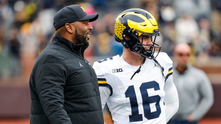 Michigan head coach Sherrone Moore talks to quarterback Davis Warren (16) at warmup during the spring game at Michigan Stadium in Ann Arbor on Saturday, April 20, 2024.