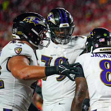 Baltimore Ravens running back Derrick Henry (22) celebrates with quarterback Lamar Jackson (8) after scoring against the Kansas City Chiefs during the first half at GEHA Field at Arrowhead Stadium.