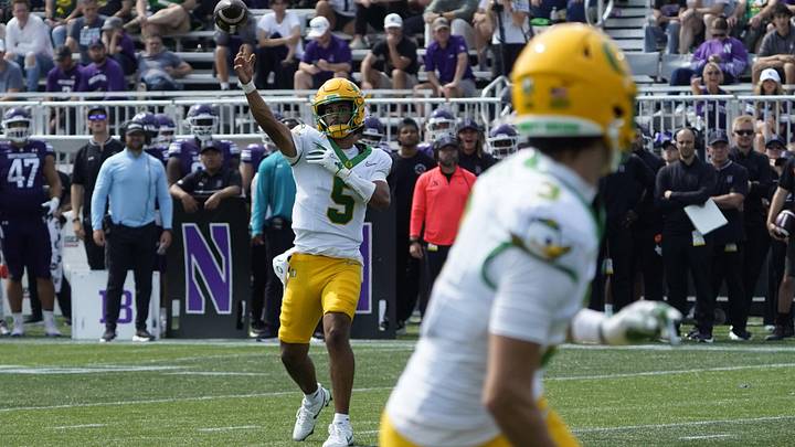Sep 13, 2025; Evanston, Illinois, USA; Oregon Ducks quarterback Dante Moore (5) throws the ball against the Northwestern Wildcats during the second half at Northwestern Medicine Field at Martin Stadium. Mandatory Credit: David Banks-Imagn Images