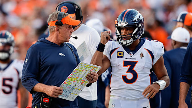 Denver Broncos head coach Sean Payton talks with quarterback Russell Wilson (3) against the Washington Commanders.