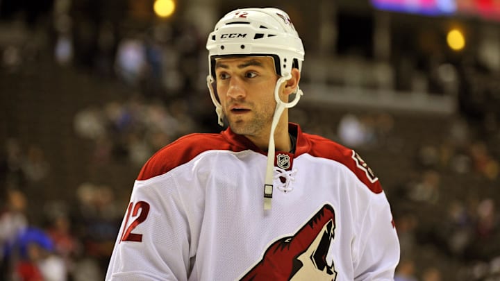 Dec 29, 2011; Denver, CO, USA; Phoenix Coyotes left wing Paul Bissonnette (12) before the start of the game against the Colorado Avalanche at the Pepsi Center. Mandatory Credit: Ron Chenoy-Imagn Images