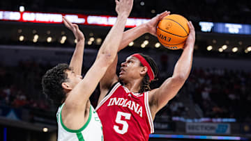 Mar 13, 2025; Indianapolis, IN, USA; Indiana Hoosiers forward Malik Reneau (5) shoots the ball while Oregon Ducks forward Brandon Angel (21) defends in the first half at Gainbridge Fieldhouse. Mandatory Credit: Trevor Ruszkowski-Imagn Images