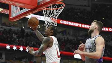 Mar 15, 2023; Chicago, Illinois, USA; Chicago Bulls forward DeMar DeRozan (11) scores past Sacramento Kings forward Domantas Sabonis (10) during the first half at the United Center. Mandatory Credit: Matt Marton-Imagn Images