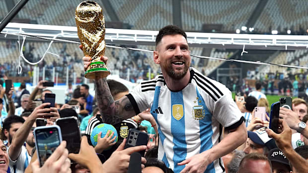 Lionel Messi lifts the World Cup.