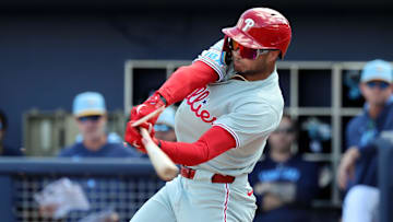 Feb 25, 2025; Port Charlotte, Florida, USA;  Philadelphia Phillies outfielder Justin Crawford (80) breaks his bat as he reaches on a fielders choice against the Tampa Bay Rays during the fourth inning at Charlotte Sports Park.