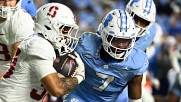 Nov 8, 2025; Chapel Hill, North Carolina, USA;  Stanford Cardinal running back Cole Tabb (33) with the ball as North Carolina Tar Heels linebacker Khmori House (7) defends in the third quarter at Kenan Stadium. Mandatory Credit: Bob Donnan-Imagn Images