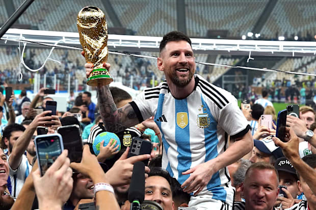 Lionel Messi lifts the World Cup.