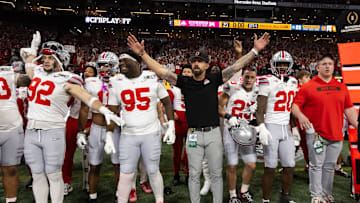 Jan 20, 2025; Atlanta, GA, USA; Ohio State Buckeyes defensive end Caden Curry (92), defensive tackle Tywone Malone Jr. (95), linebackers coach James Laurinaitis, linebacker Garrett Stover (23) and linebacker Arvell Reese (20) react as the clock hits zero in their victory over the Notre Dame Fighting Irish during the CFP National Championship college football game at Mercedes-Benz Stadium. Mandatory Credit: Mark J. Rebilas-Imagn Images