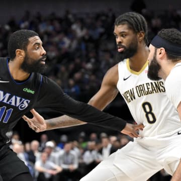 Jan 15, 2024; Dallas, Texas, USA; Dallas Mavericks guard Kyrie Irving (11) looks to move the ball past New Orleans Pelicans forward Naji Marshall (8) during the second quarter at the American Airlines Center. Mandatory Credit: Jerome Miron-USA TODAY Sports
