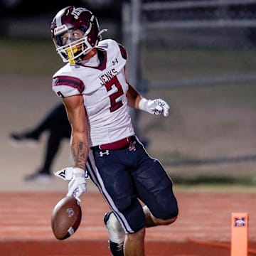 Jenks’ Kaydin Jones (2) runs the ball for a touchdown during a high school football game between Mustang and Jenks in Mustang, Okla., on Friday, Oct. 11, 2024.