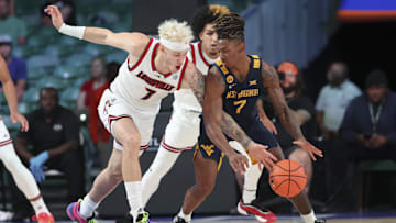 Nov 28, 2024; Paradise Island, Bahamas, BHS;  Louisville Cardinals forward Kasean Pryor (7) tries to steal the ball from West Virginia Mountaineers guard Javon Small (7) during the first half at Imperial Arena at the Atlantis resort.  Mandatory Credit: Kevin Jairaj-Imagn Images