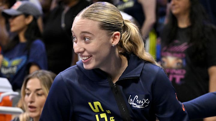 Aug 8, 2025; Arlington, Texas, USA; Dallas Wings guard Paige Bueckers (5) smiles after she avoids guard Arike Ogunbowale (not pictured) as Ogunbowale jumps out of bounds during the second half against the New York Liberty at College Park Center. Mandatory Credit: Jerome Miron-Imagn Images
