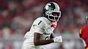 Sep 20, 2025; Los Angeles, California, USA; Michigan State Spartans wide receiver Omari Kelly (1) runs the ball against Southern California Trojans cornerback DJ Harvey (2) during the first half at the Los Angeles Memorial Coliseum.