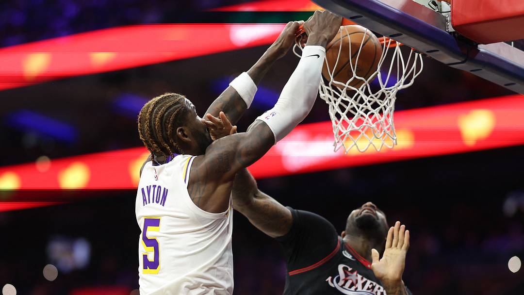 Dec 7, 2025; Philadelphia, Pennsylvania, USA; Los Angeles Lakers center Deandre Ayton (5) dunks past Philadelphia 76ers center Andre Drummond (1) during the first quarter at Xfinity Mobile Arena. Mandatory Credit: Bill Streicher-Imagn Images Dec 7, 2025; Philadelphia, Pennsylvania, USA; Los Angeles Lakers center Deandre Ayton (5) dunks past Philadelphia 76ers center Andre Drummond (1) during the first quarter at Xfinity Mobile Arena. Mandatory Credit: Bill Streicher-Imagn Images