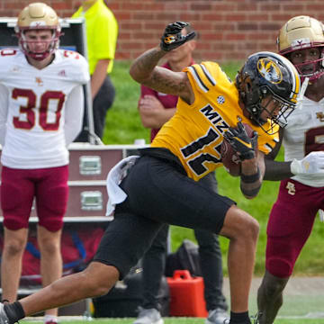 Sep 14, 2024; Columbia, Missouri, USA; Missouri Tigers cornerback Dreyden Norwood (12) intercepts a pass intended for Boston College Eagles wide receiver Jaedn Skeete (6) during the second half at Faurot Field at Memorial Stadium. Mandatory Credit: Denny Medley-Imagn Images