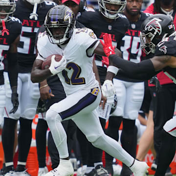 Aug 17, 2024; Baltimore, Maryland, USA; Baltimore Ravens wide receiver Malik Cunningham (12) gains yards after a second quarter catch defended by Atlanta Falcons safety Tre Tarpley III (38) at M&T Bank Stadium. Mandatory Credit: Mitch Stringer-Imagn Images