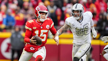 Dec 25, 2023; Kansas City, Missouri, USA; Kansas City Chiefs quarterback Patrick Mahomes (15) scrambles against Las Vegas Raiders defensive end Maxx Crosby (98) during the second half at GEHA Field at Arrowhead Stadium. Mandatory Credit: Jay Biggerstaff-Imagn Images