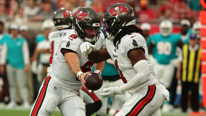 Aug 23, 2024; Tampa, Florida, USA; Tampa Bay Buccaneers quarterback Baker Mayfield (6) hands the ball off to running back Rachaad White (1) against the Miami Dolphins  during the first quarter at Raymond James Stadium. Mandatory Credit: Kim Klement Neitzel-USA TODAY Sports