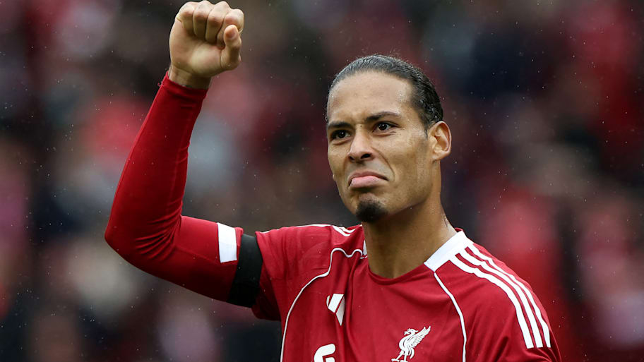 Virgil van Dijk with an arm raised aloft.