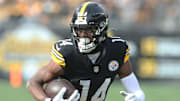 Nov 17, 2024; Pittsburgh, Pennsylvania, USA;  Pittsburgh Steelers wide receiver George Pickens (14) runs after a  catch against the Baltimore Ravens during the first quarter at Acrisure Stadium. Mandatory Credit: Charles LeClaire-Imagn Images